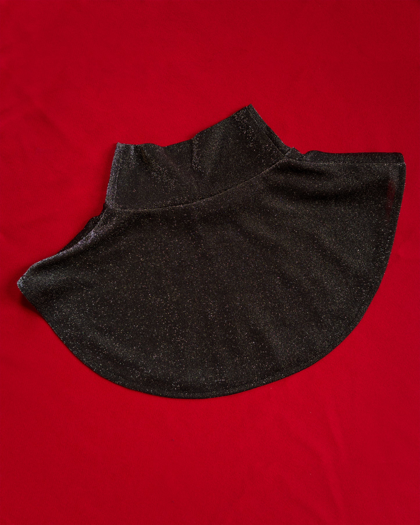 Soft, polyester knit metallic removable collar. Shimmer is fallout-free, and color shifts between black, silver, purple, blue, and green.