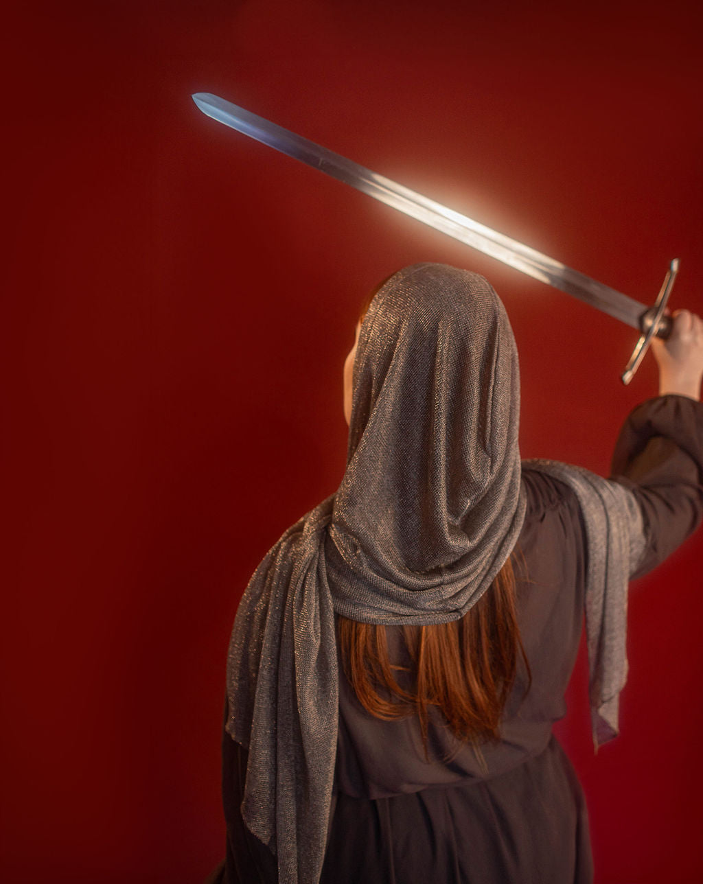 Silver hooded scarf made from a soft, knitted, renaissance faire - friendly fabric resembling chainmaille. Featured here with our Reliquary Robe wrap.