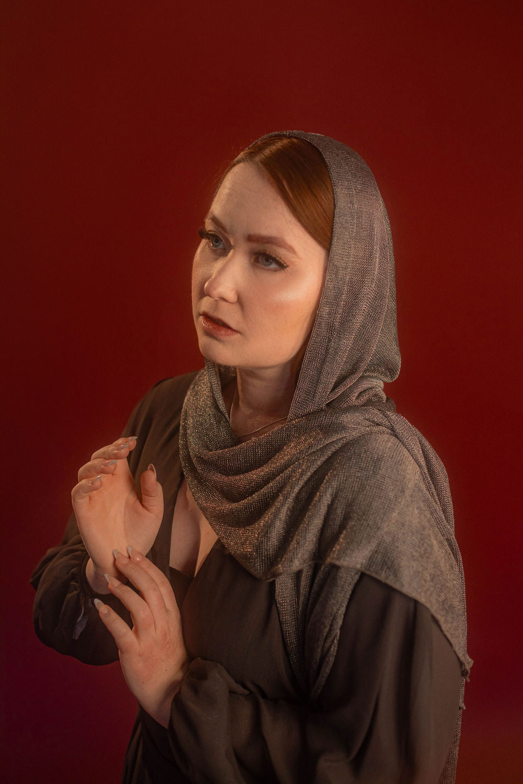 Silver hooded scarf made from a soft, knitted, renaissance faire - friendly fabric resembling chainmaille. Featured here with our Reliquary Robe wrap.
