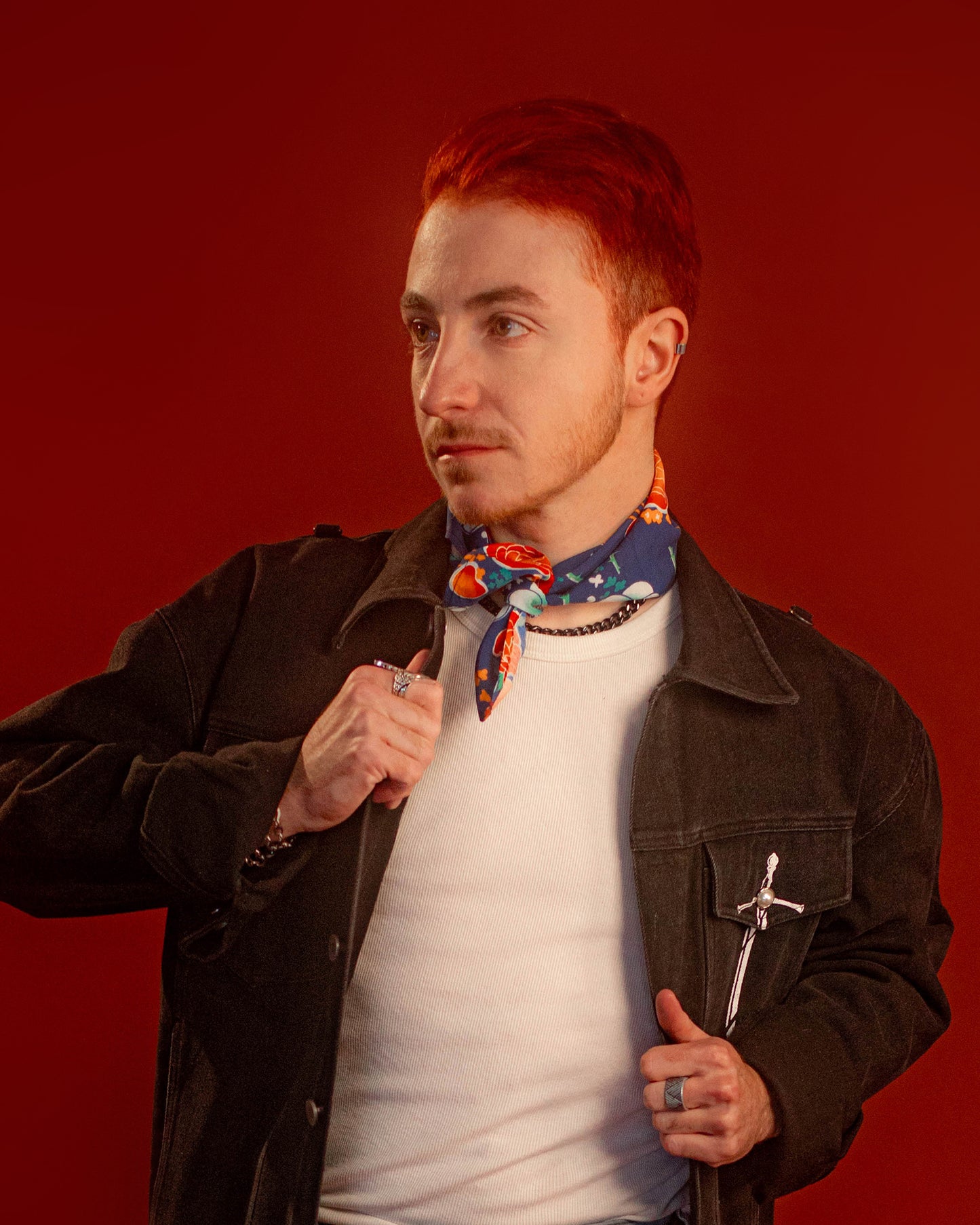 Blue, red, orange, and teal floral patterned rayon bandana accessory with a silky feel. Matches both pattern and fabric as our Montague Button Down Hawaiian-style shirt. Featured here as a pop of color on our Good Luck Jeanne denim Jacket.