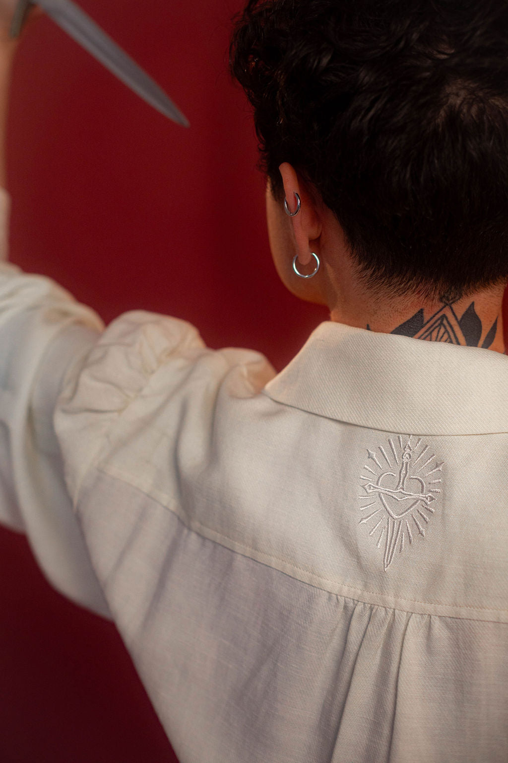 Soft, off-white tencel and linen blend to make the soft, flowy, draped shape of our poet shirt. Tone-on-tone embroidery on the collars, cuffs, and back yoke and buttons down the front and cuffs.