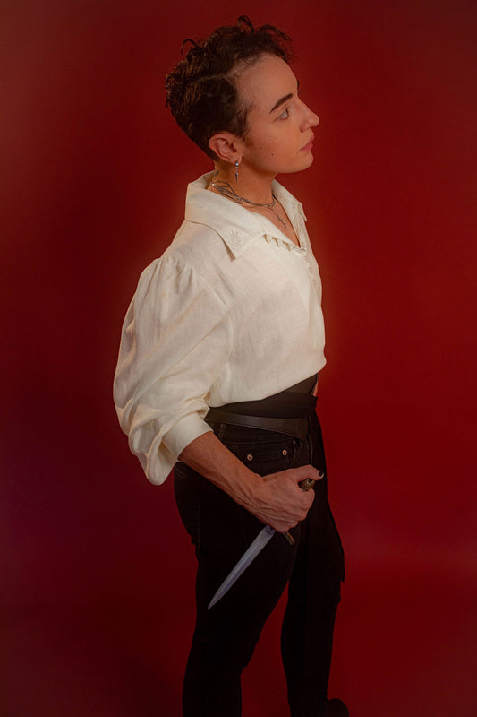 Soft, off-white tencel and linen blend to make the soft, flowy, draped shape of our poet shirt. Tone-on-tone embroidery on the collars, cuffs, and back yoke and buttons down the front and cuffs.