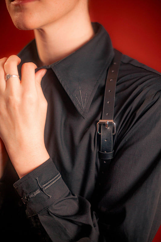 black cotton twill button up with a large black sword embroidered down the placket, and smaller swords embroidered on the collar points and cuffs.