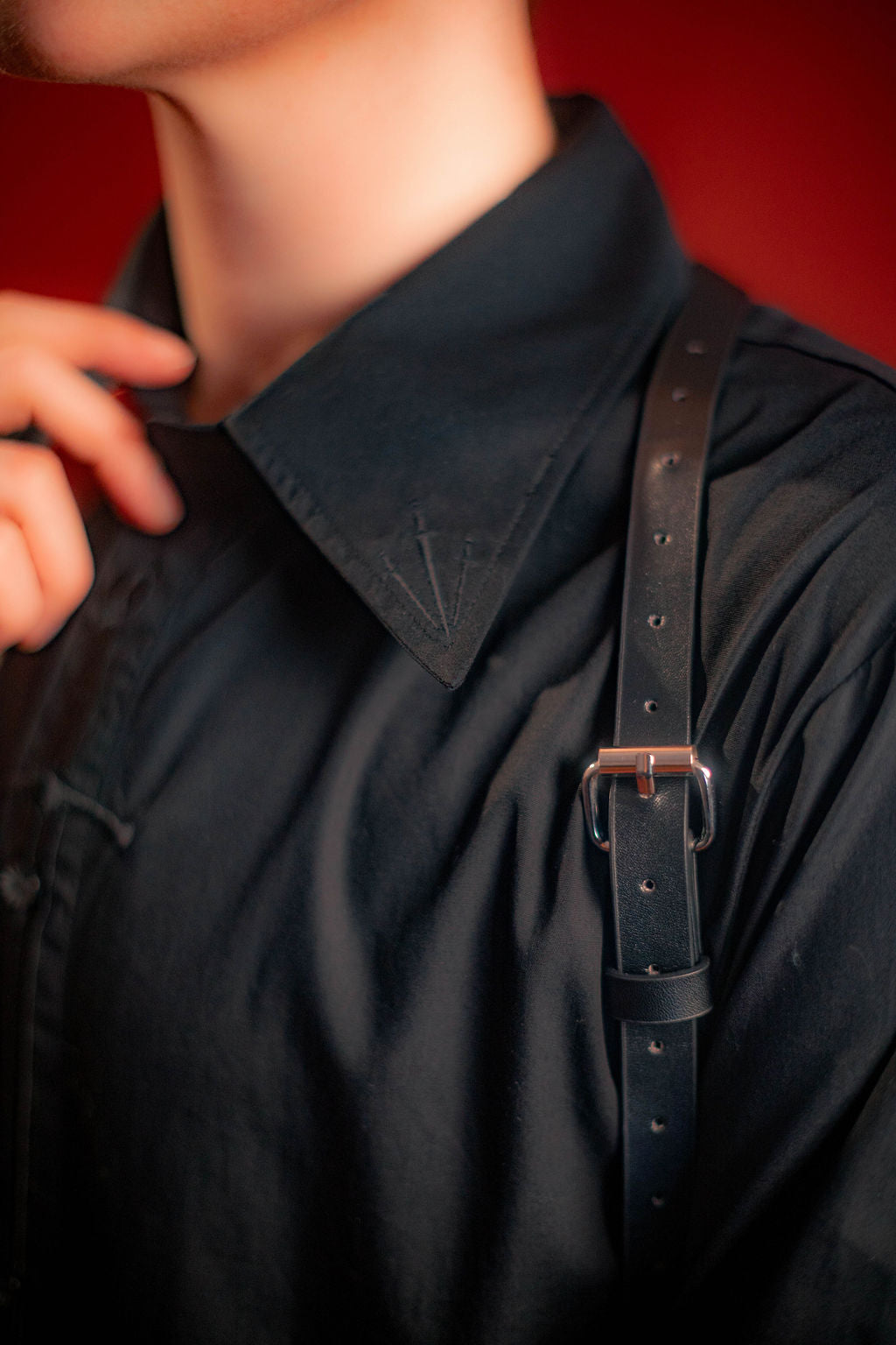 black cotton twill button up with a large black sword embroidered down the placket, and smaller swords embroidered on the collar points and cuffs.