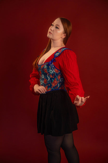 Reversible corset top with floral brocade matching our Montague button up and Lovers Favor bandana on one side and a cobalt blue cotton twill on the other with a printed red, orange, yellow, teal, and silver sacred heart in the middle. Nylon boning for shape, red and blue pairs of satin ribbon to tie removable straps and lace up the back. 