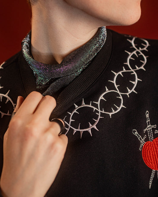 Soft, polyester knit metallic removable collar. Shimmer is fallout-free, and color shifts between black, silver, purple, blue, and green. Featured under our Devotion Crewneck.
