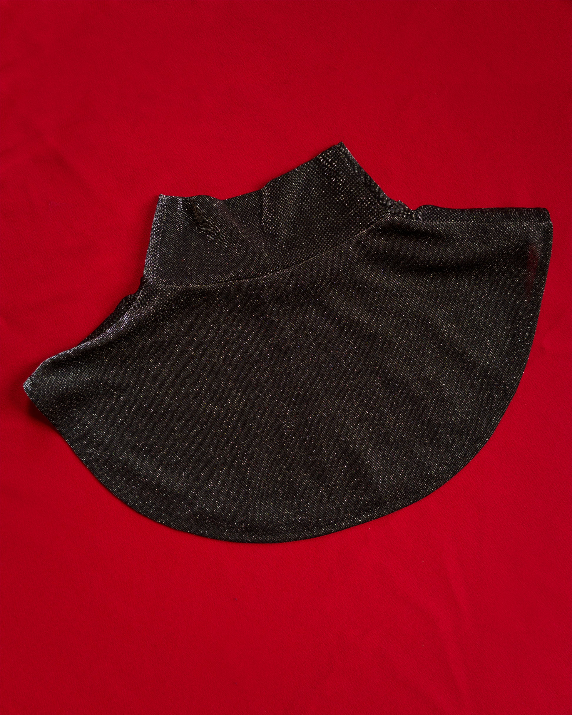 Soft, polyester knit metallic removable collar. Shimmer is fallout-free, and color shifts between black, silver, purple, blue, and green. 