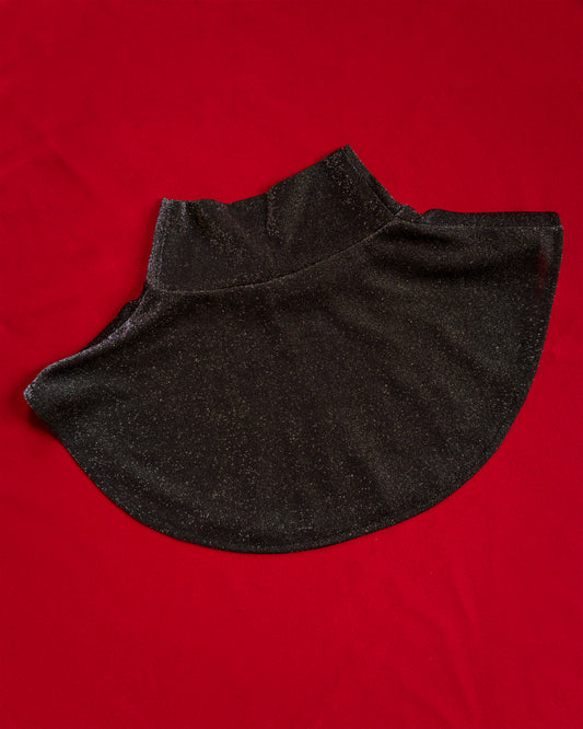 Soft, polyester knit metallic removable collar. Shimmer is fallout-free, and color shifts between black, silver, purple, blue, and green. 