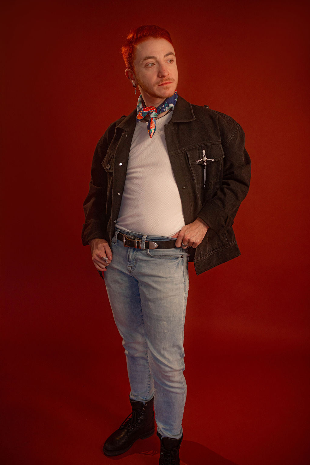 Black sturdy cotton denim jacket with white screen-printed sword on chest pocket and sacred heart graphic on a back patch. Custom pearl button on front pocket aligned with sword's pommel, five pockets, and multiple reinforced D rings for clipping accessories on to, like our Heart On Your Pocket Chain. Shown here with our Lovers Favor Bandana.