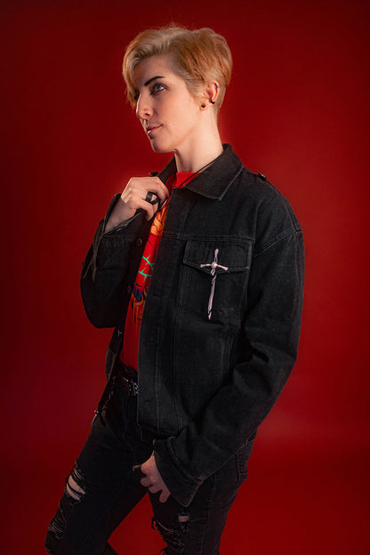 Black sturdy cotton denim jacket with white screen-printed sword on chest pocket and sacred heart graphic on a back patch. Custom pearl button on front pocket aligned with sword's pommel, five pockets, and multiple reinforced D rings for clipping accessories on to, like our Heart On Your Pocket Chain. Shown here with our Lovers Favor Bandana.