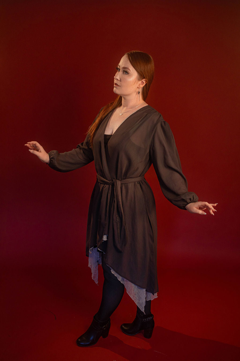 Soft, polyester grey and silver chiffon layered into a sheer, knee-length robe wrap dress. Features a tone-on-tone embroidered sword down the back, and two embroidered on a matching detachable waist tie.