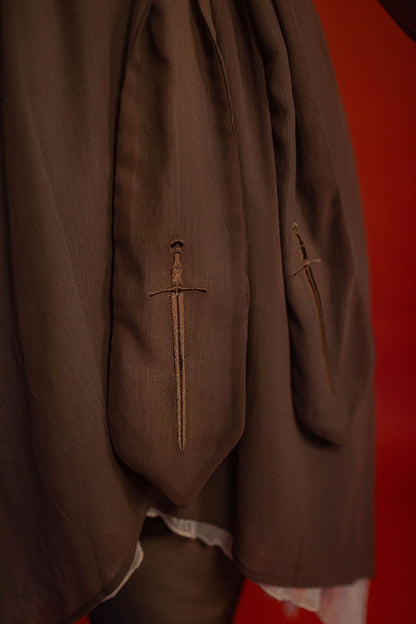 Soft, polyester grey and silver chiffon layered into a sheer, knee-length robe wrap dress. Features a tone-on-tone embroidered sword down the back, and two embroidered on a matching detachable waist tie.