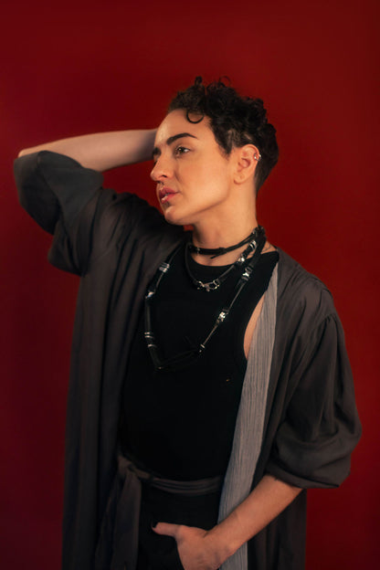 Soft, polyester grey and silver chiffon layered into a sheer, knee-length robe wrap dress. Features a tone-on-tone embroidered sword down the back, and two embroidered on a matching detachable waist tie.