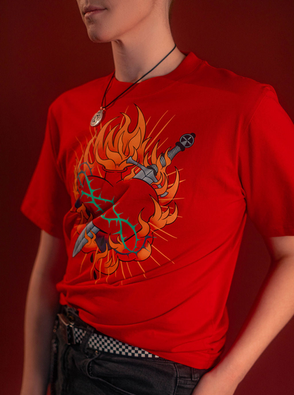 Fire red cotton tshirt with a full-color print on the front featuring the custom yellow, orange, teal, and silver flaming heart graphic with dagger and thorns. Printed collar tag information, and Saints & Sonnets logo hem tag.